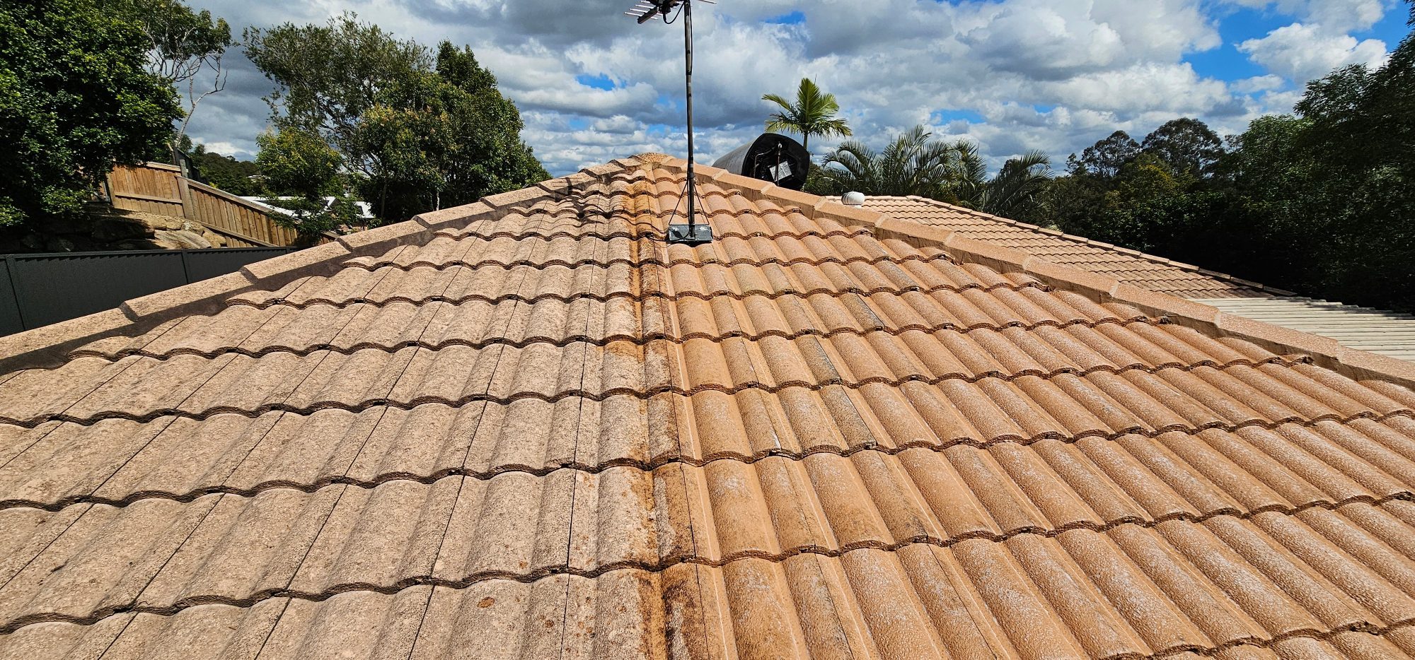 Tiled roof being cleaned by softwash
