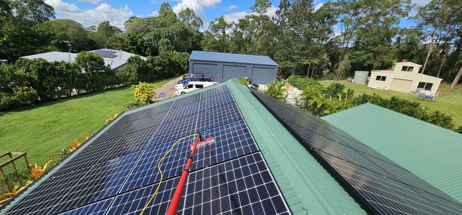 Solar panels being cleaned with a soft brush